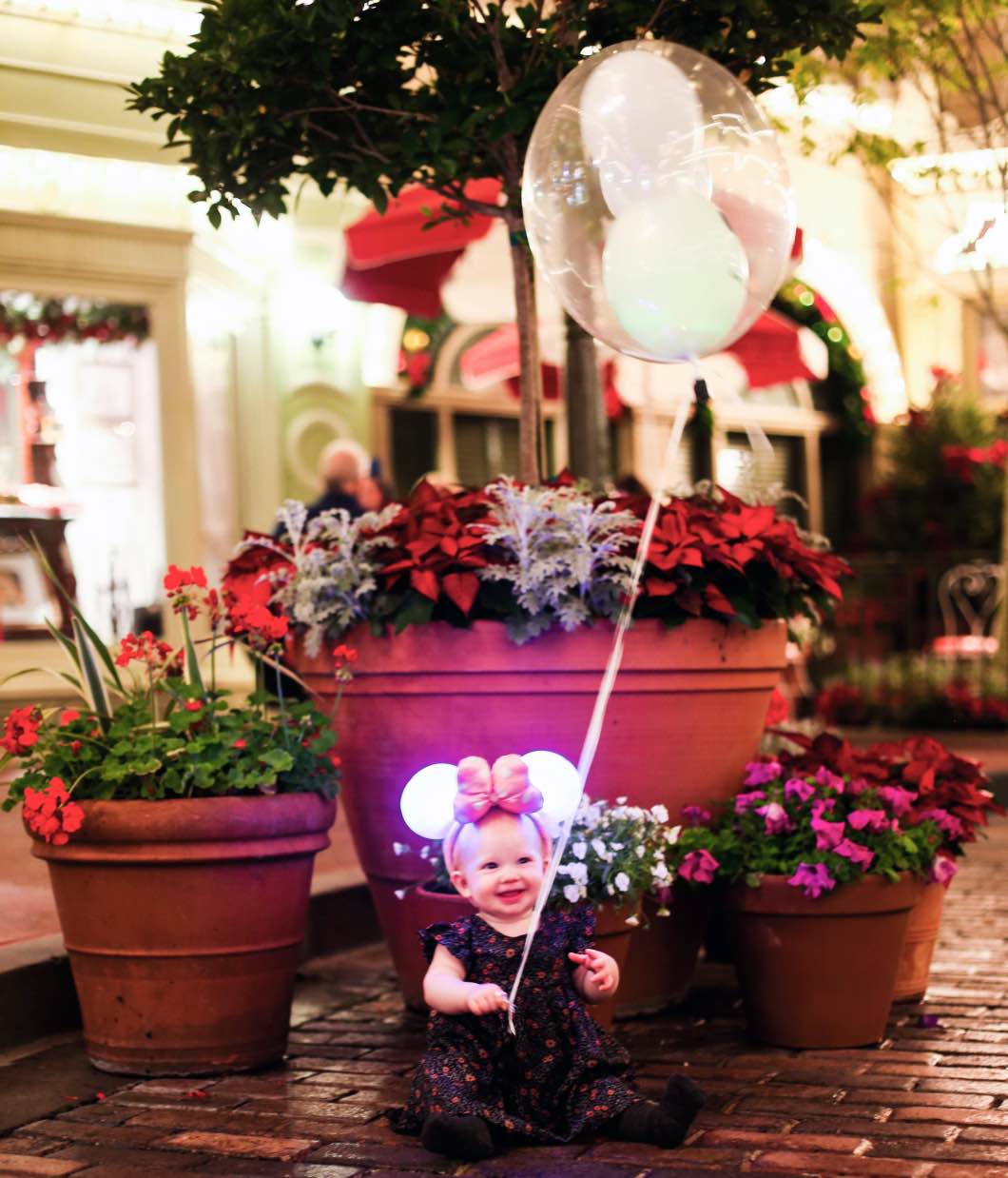Mickeys Very Merry Christmas Main Street baby - Holiday Attractions in Orlando by Atlanta travel blogger Happily Hughes