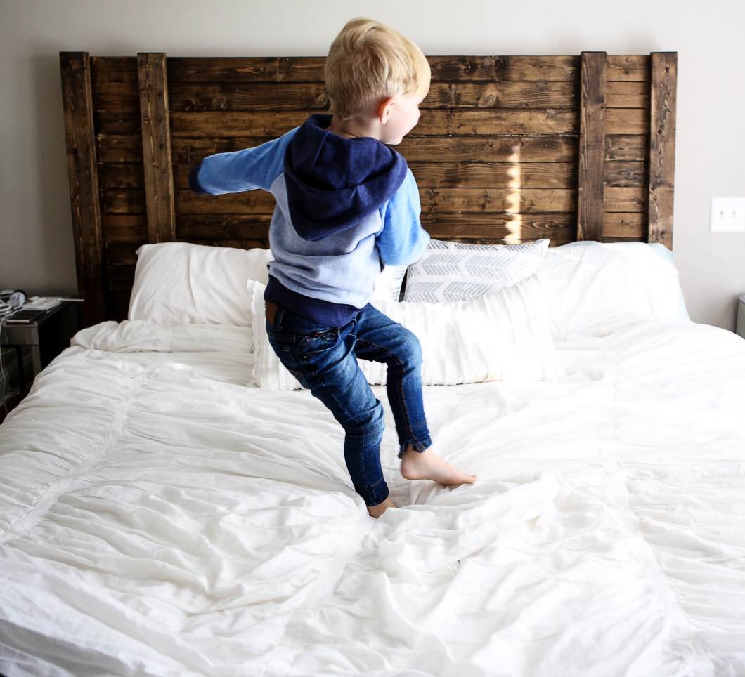 toddler jumping on the bed