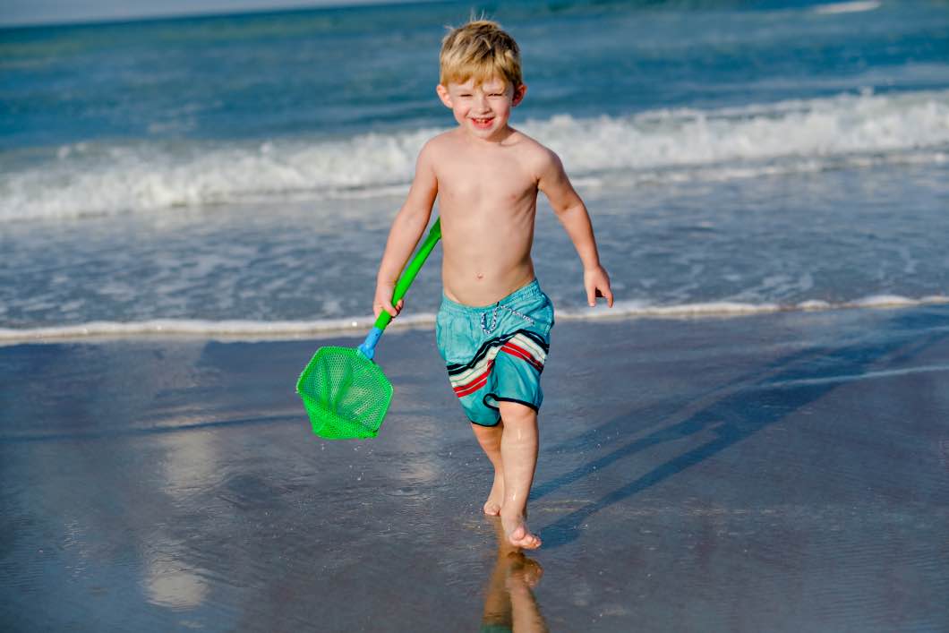 child having fun daytona beach - Daytona Beach Family Vacation by Atlanta mom blogger Happily Hughes