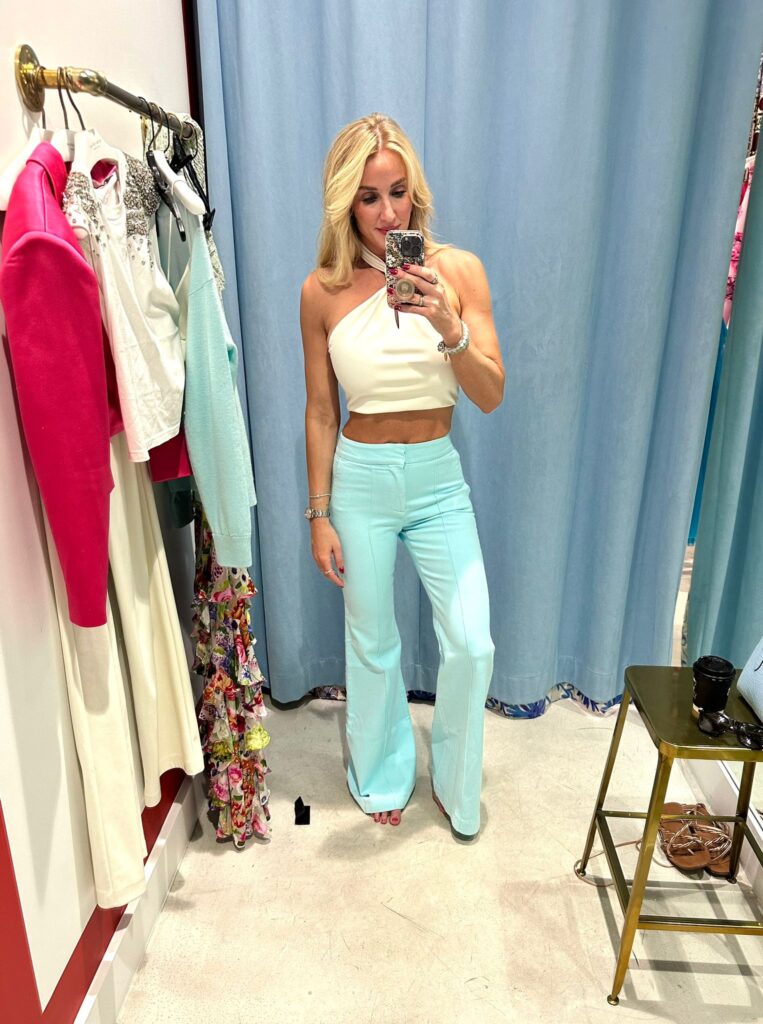 Jessica wearing baby blue trouser pants with a white crop top!