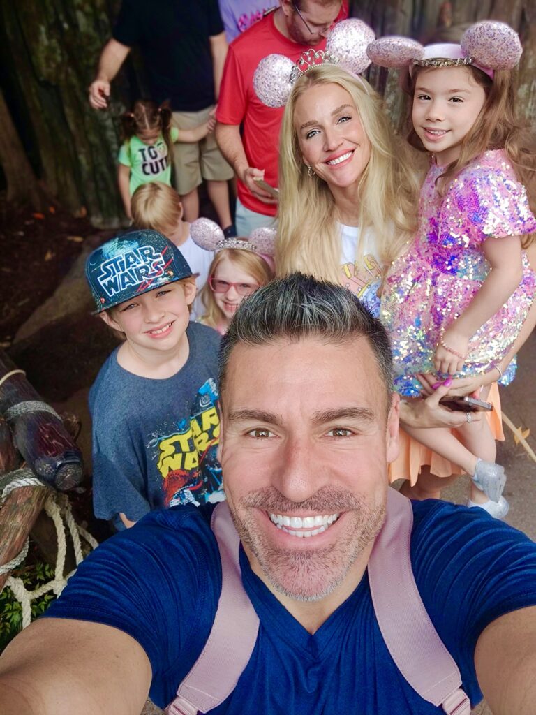 Full family photo, photo taken by David as a selfie and all the kids and Jess are standing behind him. Here is our Ultimate Disney World Orlando Travel Guide